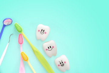 Teeth toys smile emotion with dental mirror ,dental plaque cleaning tool and tooth brush on green background, with Clipping path and copy space for your text