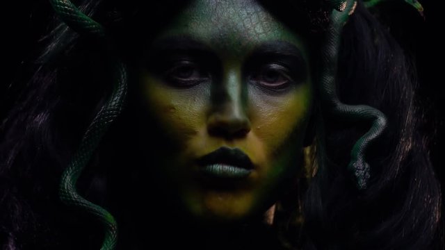Legendary Gorgon swallows a snake and licks her lips