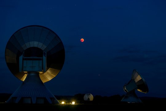 Parabolic antennas with blood moon at lunar eclipse, night shot, Raisting, Upper Bavaria, Germany, Europe