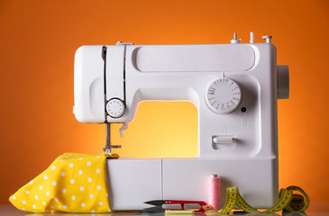 White electric sewing machine in the workplace of seamstress