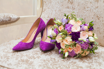 bridal shoes and bouquet of flowers