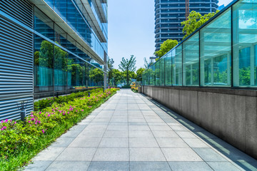 empty pavement and modern buildings in city.