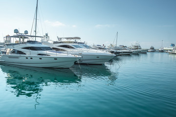 small boats and yachts are in the berth of the seaport of Sochi on the Black sea bright sunny summer day