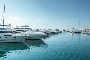 small boats and yachts are in the berth of the seaport of Sochi on the Black sea bright sunny summer day
