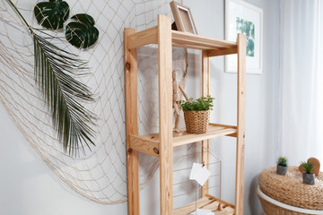 Shelving unit with green plant and decor in room
