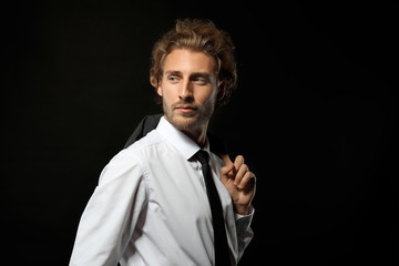 Handsome businessman on black background