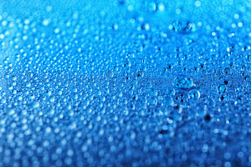 Drops of water on color background