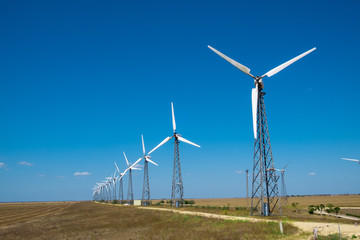 many of the old windmills standing in the fields of the Crimea in the summer day