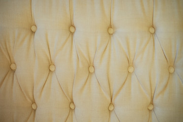 Texture, classic sofa upholstery with light fabric buttons.