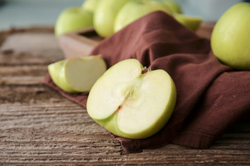 Cut tasty apples on wooden table