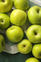 Ripe tasty apples on color table