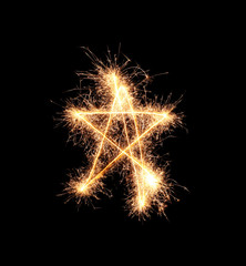Shining star made of sparklers on dark background