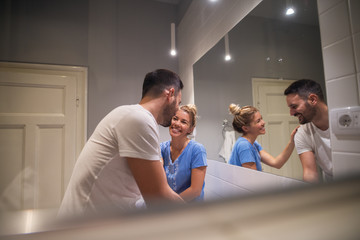 Smiling happy couple talking early in the morning in their bathroom.