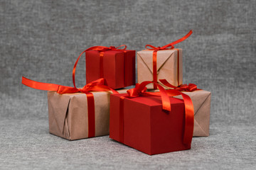 The gift box is wrapped in a red ribbon, on a gray background