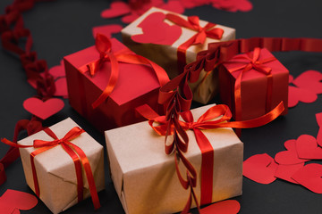 the gift box is wrapped in a red ribbon, a scroll wrapped in a red ribbon, and paper hearts around,...