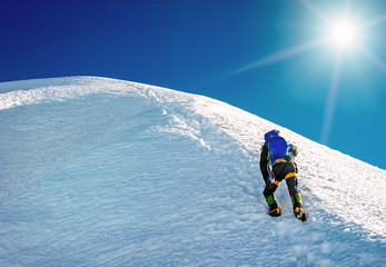 Climber reaches the summit of mountain peak. Climbing and mountaineering sport concept, Nepal Himalayas