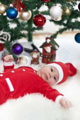 little baby dresed up as santa claus