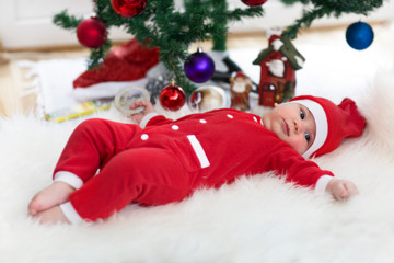 little baby dresed up as santa claus