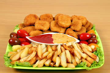 chicken nuggets and french fries on plate fast food