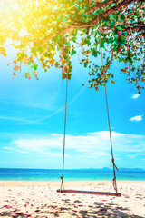 Beautiful Maldive beach. Swing hang from tree over beach. Summer holiday and vacation concept.