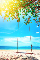Beautiful Maldive beach. Swing hang from tree over beach. Summer holiday and vacation concept.