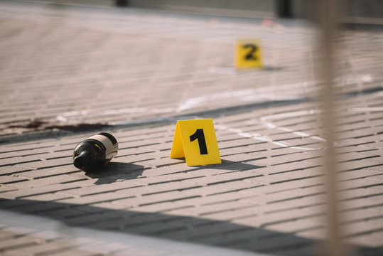 Close Up View Of Crime Scene With Chalk Line And Numbers