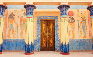 Ancient Egyptian writing on stone in Egypt. Hieroglyphs on the door. Hieroglyphic carvings on the...