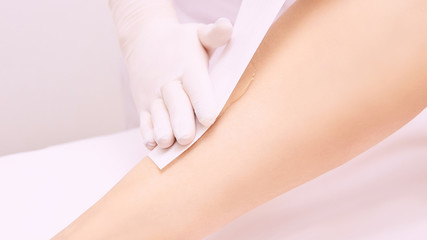 Obraz na płótnie Canvas Depilation spa procedure. Woman hair remove waxing. Epilation sugaring. Legs foot