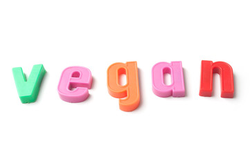 closeup of colorful plastic letters on white background - Vegan
