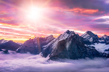 Naklejka na ściany i meble Winter scene with sunset in mountains