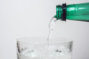 Pouring water from bottle into glass