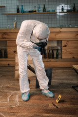 forensic investigator documenting evidence with camera at crime scene