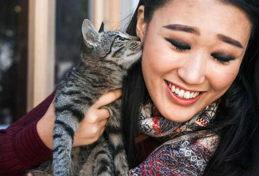 Happy woman spending time with her cat