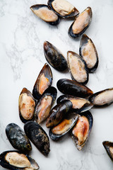 Top view with frozen mussels on white marble background