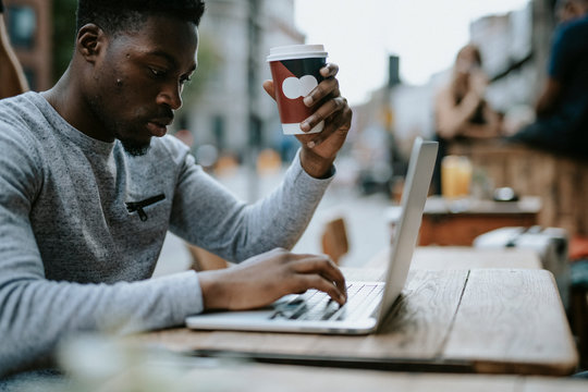 Man working on a laptop at a cafe