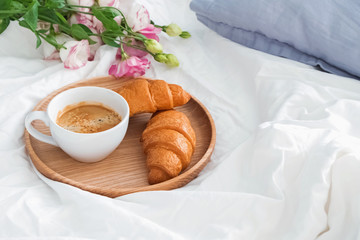 Breakfast in bed with coffee and croissants