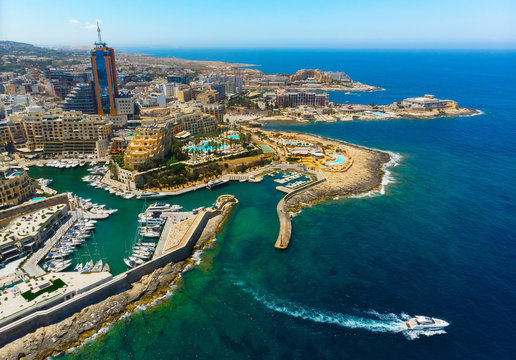 Aerial view of St. Julian's city and Portomaso tower and boat in the sea. Malta country in the Europe