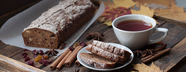 Homemade banana bread with anis star and cinnamon on a dark wooden background