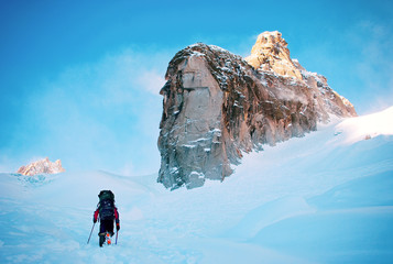 Tourist with a backpack and mountain panorama. Extreme sport concept