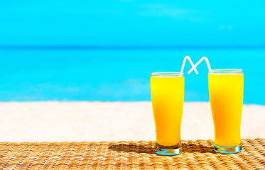 Two tropical fresh juices on tropical beach. Holiday and vacation concept.