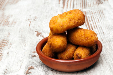 Croquettes surrounded by rustic background