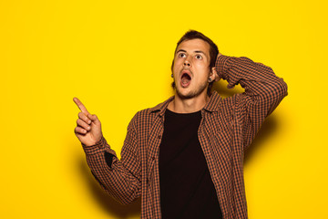 Guy with facial expression of shock and pointing to the camera