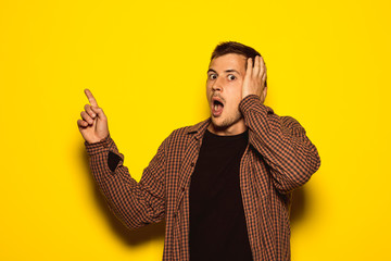Guy with facial expression of shock and pointing to the camera
