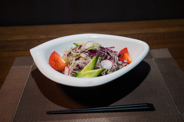 Close up view of plate with japanese food inside. Japan traditional food on wooden table. Selective focus