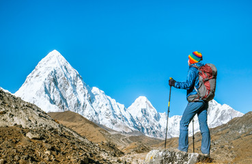Hiker with backpacks reaches the summit of mountain peak. Success, freedom and happiness,...