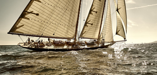 Sailboat under white sails at the regatta. Sailing yacht race - obrazy, fototapety, plakaty