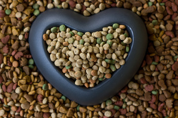 Heart bowl filled by dry pet food