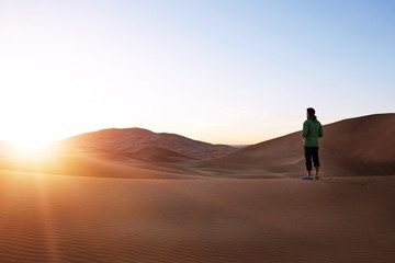 Fototapeta na wymiar Hinking in the sand dunes in the Sahara Desert. Morocco, Africa