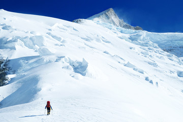 Fototapeta na wymiar Mountaineer ascending summit 