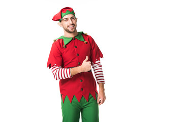 smiling man in christmas elf costume looking at camera and doing thumbs up sign isolated on white